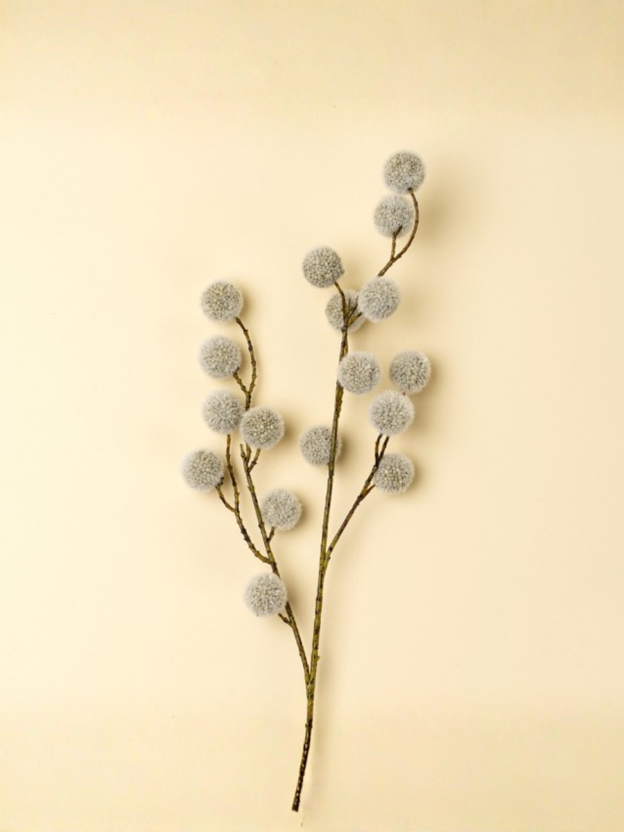 Decorative branch with fluffy pom-poms