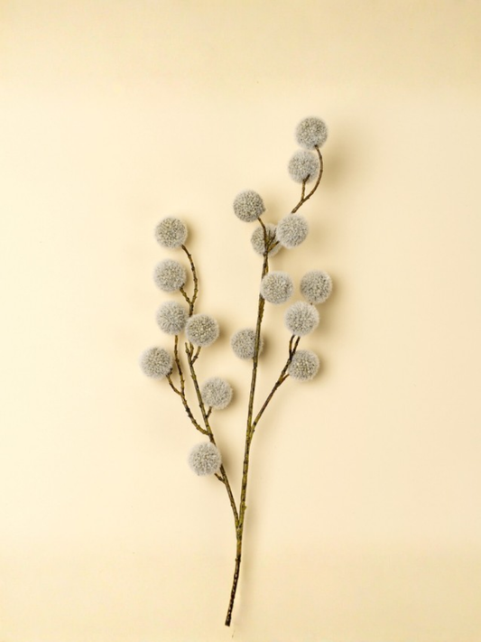 Decorative branch with fluffy pom-poms